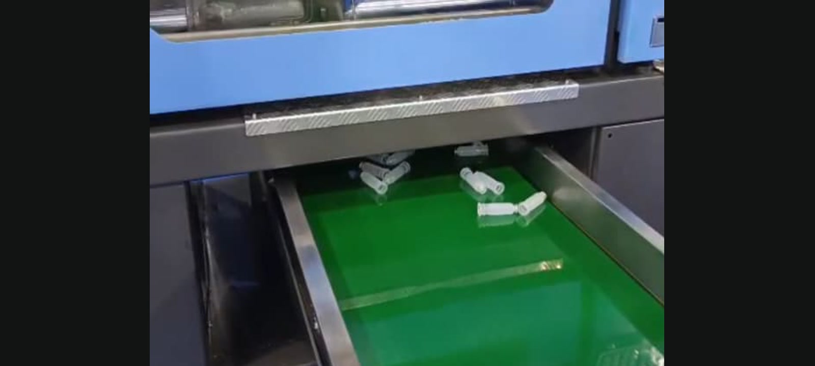 Polypropylene bottles leaving the blow-moulding machine